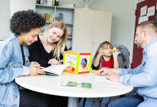 A young family sits in the office of a day-care centre management and seeks advice.