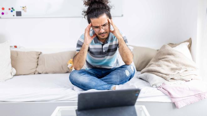 Desperate student sitting in front of laptop