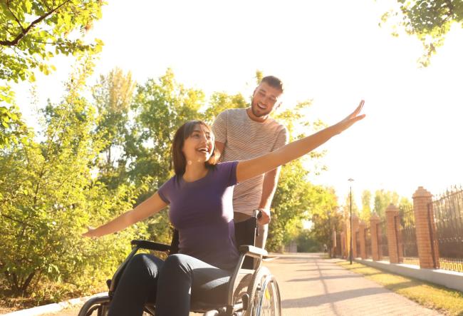 Student in wheelchair happy.