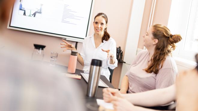 Group listening to a person, who is presenting