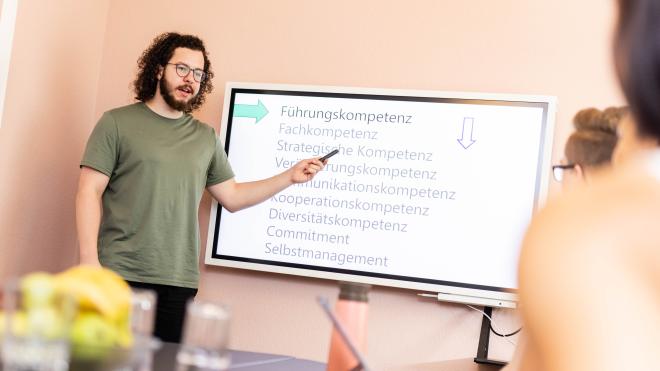 Man presenting on a smart board