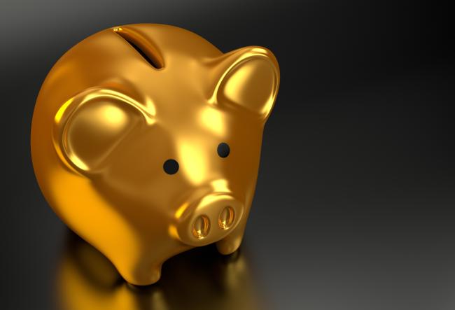 Golden piggy bank on a black background.