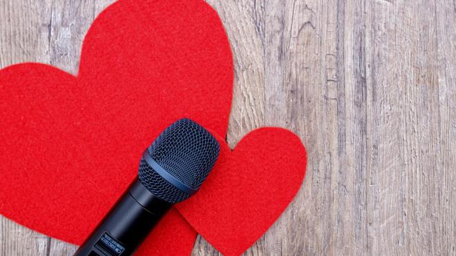 Microphone placed on two red paper hearts